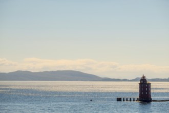Kjeungskjær Fyr, red lighthouse, off the Norwegian coast on a small archipelago off Ã˜rland,