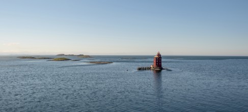 Kjeungskjær Fyr, red lighthouse, off the Norwegian coast on a small archipelago off Ã˜rland,