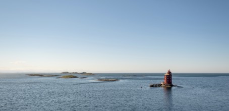 Kjeungskjær Fyr, red lighthouse, off the Norwegian coast on a small archipelago off Ã˜rland,