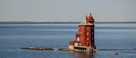 Kjeungskjær Fyr, red lighthouse, off the Norwegian coast on a small archipelago off Ã˜rland,
