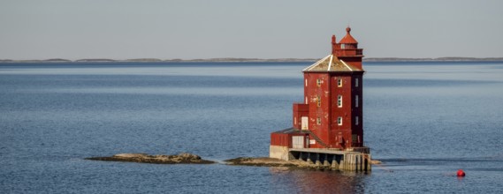 Kjeungskjær Fyr, red lighthouse, off the Norwegian coast on a small archipelago off Ã˜rland,