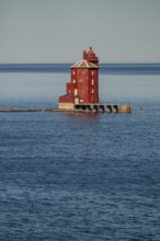 Kjeungskjær Fyr, red lighthouse, off the Norwegian coast on a small archipelago off Ã˜rland,