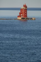 Kjeungskjær Fyr, red lighthouse, off the Norwegian coast on a small archipelago off Ã˜rland,