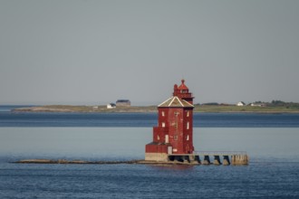 Kjeungskjær Fyr, red lighthouse, off the Norwegian coast on a small archipelago off Ã˜rland,