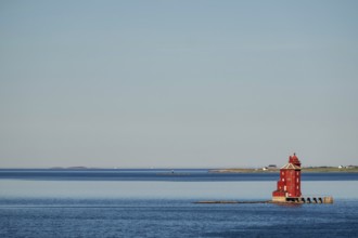 Kjeungskjær Fyr, red lighthouse, off the Norwegian coast on a small archipelago off Ã˜rland,