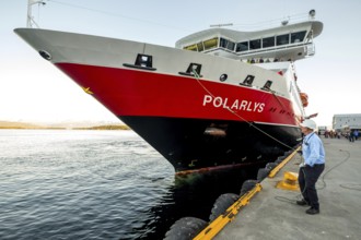 Sailor, sailor mooring the ship MS Polarlys at the quay, harbour bollard with mooring line, Molde