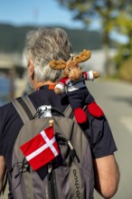 Tourist with backpack and cloth cup and Norwegian flag, travel guide, tour guide, tourist guid,