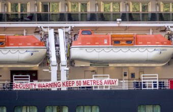 Ship RMS Queen Elizabeth, warning to sea pirates, security warning keep 50 metres away, lifeboats,