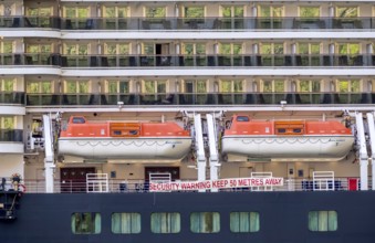 Ship RMS Queen Elizabeth, warning to sea pirates, security warning keep 50 metres away, lifeboats,