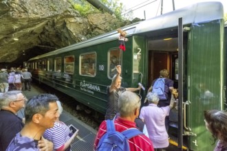 Kjosfossen waterfall, tourists boarding Flams Railway, mountain, rock, tunnel, Flåm, Sogn og