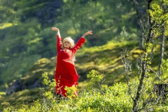 Woman dressed in red is a Huldra, fairy, legendary figure, Kjosfossen waterfall, waterfall near