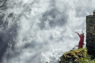 Red dressed woman is a Huldra, fairy, legendary figure, Kjosfossen waterfall, waterfall near