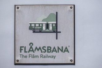 Journey on the Flam Railway, iron railway, white sign with green lettering Flåmsbana, The Flam