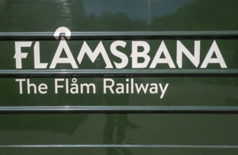 Journey on the Flam Railway, iron railway, green train with white lettering FlÃ¥msbana, The Flam