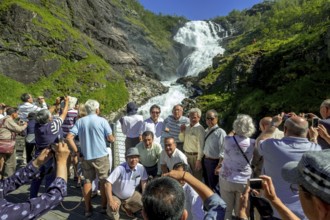 Kjosfossen waterfall, photographing tourists, waterfall near Fureberget, mountain, rock faces,