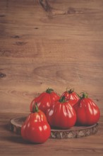 Khinkali tomatoes, on a wooden cutting board, wooden background, no people