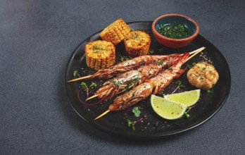 Langoustines on skewers, shrimp kebab, with fried corn, spices and herbs, homemade, no people