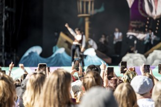 Festival visitors celebrate with Conan Gray at the Superbloom Festival and film his performance,