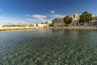 City beach Spiaggetta del Molo or Spiaggia dei Bambini and the old town centre of Otranto, Apulia,