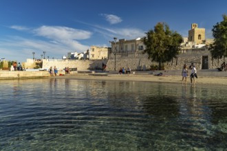 City beach Spiaggetta del Molo or Spiaggia dei Bambini and the old town centre of Otranto, Apulia,