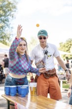Festival visitors play beer pong at the Superbloom Festival Beerpong, Day 2 in the Olympic Park,