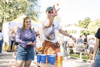 Festival visitors play beer pong at the Superbloom Festival Beerpong, Day 2 in the Olympic Park,
