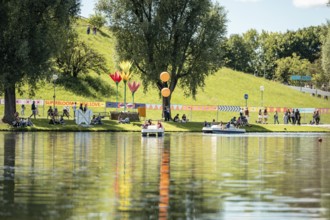 Festival visitors ride a pedal boat at the Superbloom Festival, Day 2 in the Olympic Park, Munich,