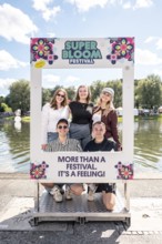 Festival visitors pose in a picture frame at the Superbloom Festival, Day 2 in the Olympic Park,