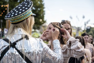 Festival visitors are made up with glitter at the Superbloom Festival, Day 2 in the Olympic Park,