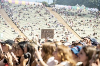 Festival visitors hold up a sign I'd like to kiss you at 01099 at the Superbloom Festival, day 2 in