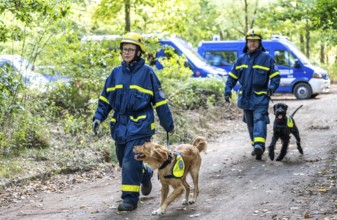 Dog handlers with rescue dogs from the Specialist Locating Group get ready for action, the sniffer