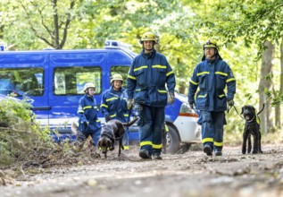 Dog handlers with rescue dogs from the Specialist Locating Group get ready for action, the sniffer