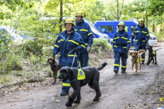 Dog handlers with rescue dogs from the Specialist Locating Group get ready for action, the sniffer