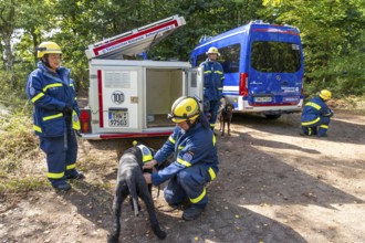 Dog handlers with rescue dogs from the Specialist Locating Group get ready for action, the sniffer