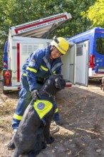 Dog handlers with rescue dogs from the Specialist Locating Group get ready for action, the sniffer