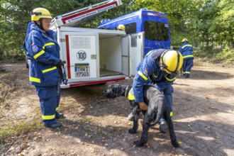 Dog handlers with rescue dogs from the Specialist Locating Group get ready for action, the sniffer