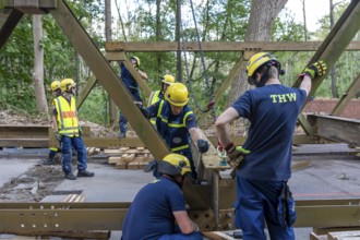 Construction of a temporary bridge over a slipped road crossing a stream, by the bridge