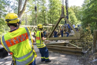 Construction of a temporary bridge over a slipped road crossing a stream, by the bridge