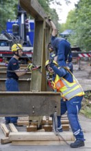 Construction of a temporary bridge over a slipped road crossing a stream, by the bridge