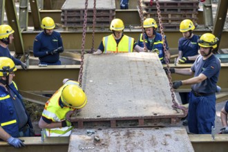 Construction of a temporary bridge over a slipped road crossing a stream, by the bridge