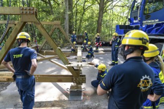 Construction of a temporary bridge over a slipped road crossing a stream, by the bridge