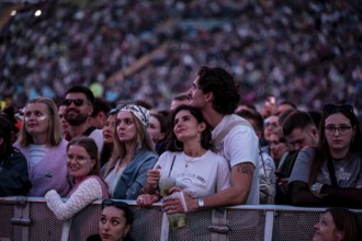 Visitors cuddle during Raye's performance at the Superbloom Festival, Day 1 at the Olympiapark,