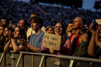 Visitor shows sign at the performance of Raye at the Superbloom Festival, Day 1 at the Olympiapark,