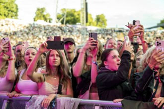 Visitors film the performance of Nelly Furtado with their mobile phones at the Superbloom Festival,