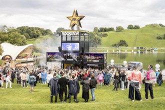Festival visitors celebrate on the Rockstar Energy Tower at the Superbloom Festival, Day 1 in the