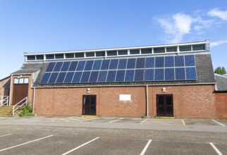 Solar panels on roof of Woodbridge Community Hall, community centre building, Woodbridge, Suffolk,