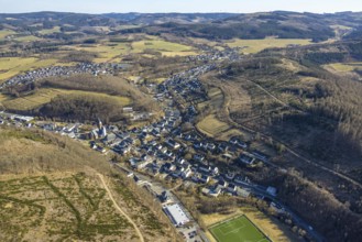 Aerial view, residential area local view, wooded area hilly landscape with forest damage, Church of