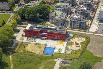Aerial view, community primary school Schule am Schloss with red facade, roof with solar panels,