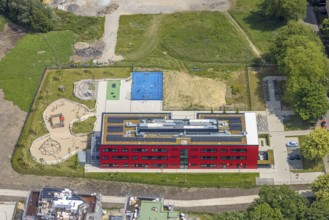 Aerial view, community primary school Schule am Schloss with red facade, roof with solar panels,