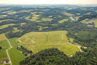 Aerial view, open space green area Am Wasserturm, hilly landscape with forest area, cycle paths and